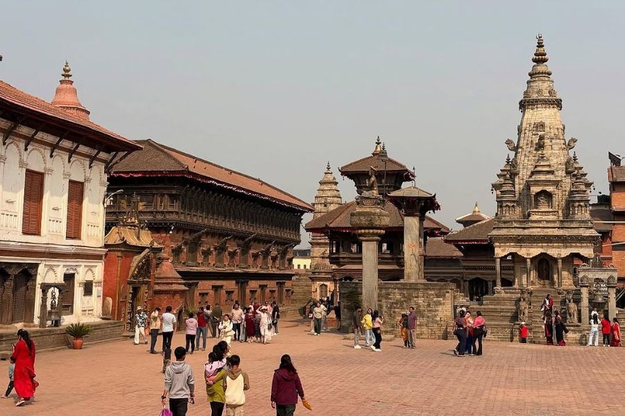 Bhaktapur Durbar Square with traditional pagoda temples and tourists.